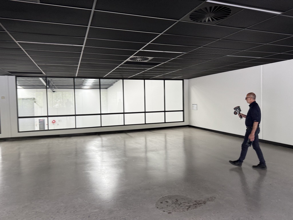 Surveyor in Melbourne using a hand held 3D scanner to create a marketing drawing